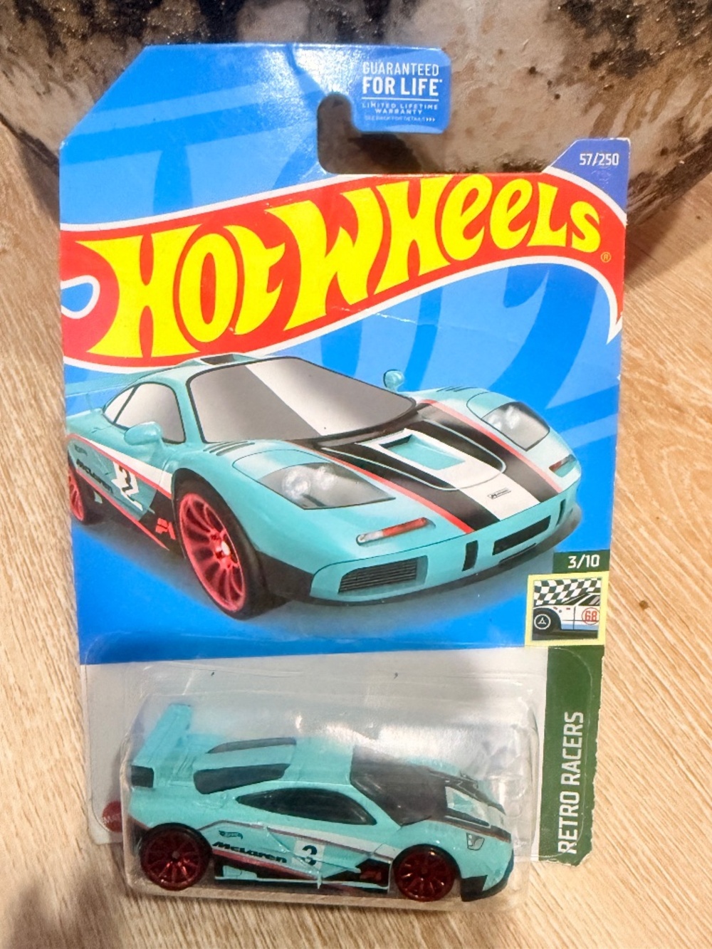 Region shows a 1:64 scale Hot Wheels McLaren F1 GTR from the 2022